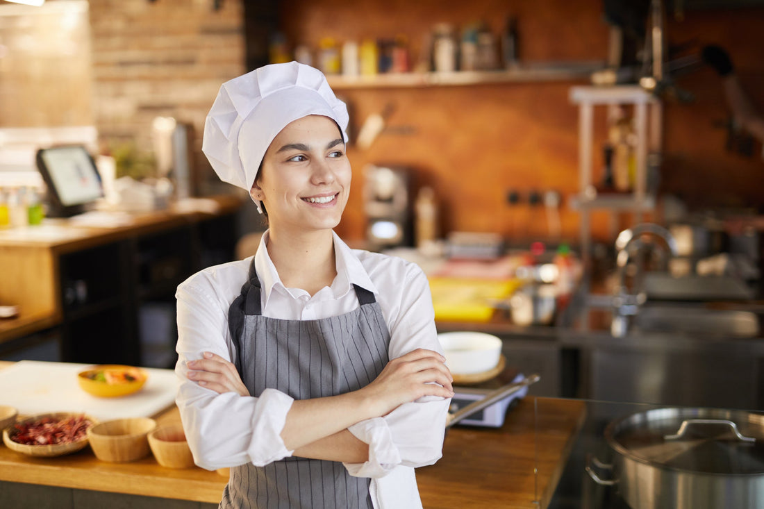A woman chef in a café with an open kitchen 
